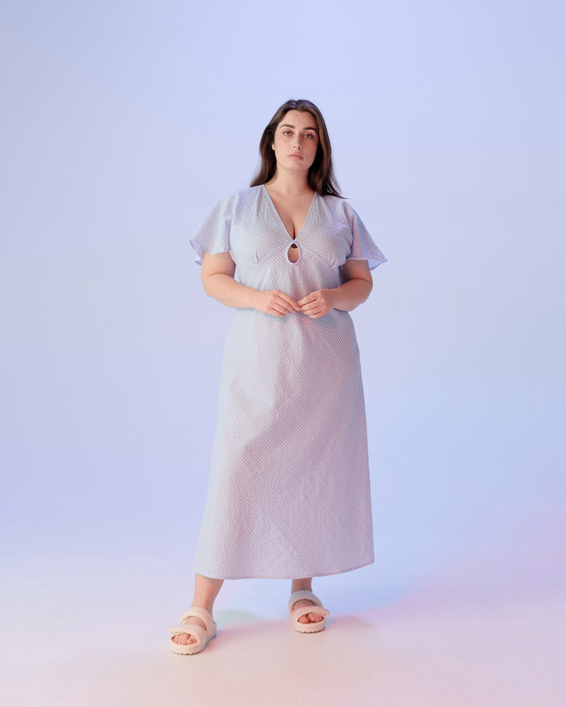 CLOVER MIDI DRESS PALE BLUE | V-neck midi dress with front keyhole detail, made in a lightweight cotton gingham. Fitted around the waist flowing to an A-line skirt, this dress is a timeless piece.