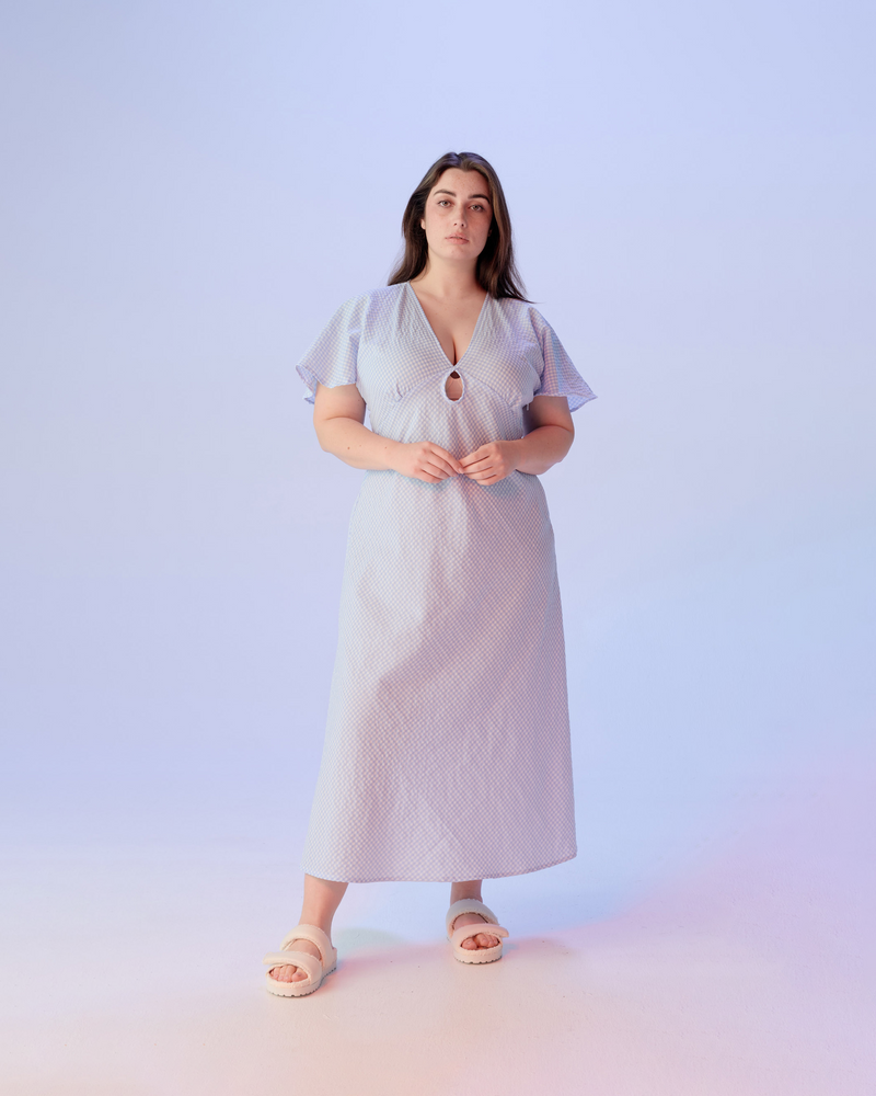 CLOVER MIDI DRESS BLUE GINGHAM | V-neck midi dress with front keyhole detail, made in a lightweight cotton gingham. Fitted around the waist flowing to an A-line skirt, this dress is a timeless piece.