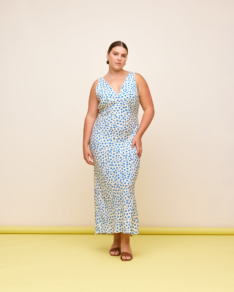 ESME SLIP DRESS BLUE SCATTER HEARTS | Bias cut midi dress in a our RUBY 'scatter hearts' print. Wide straps and a panelled V-neck front and back give this dress a vintage shape. Features a waist tie...