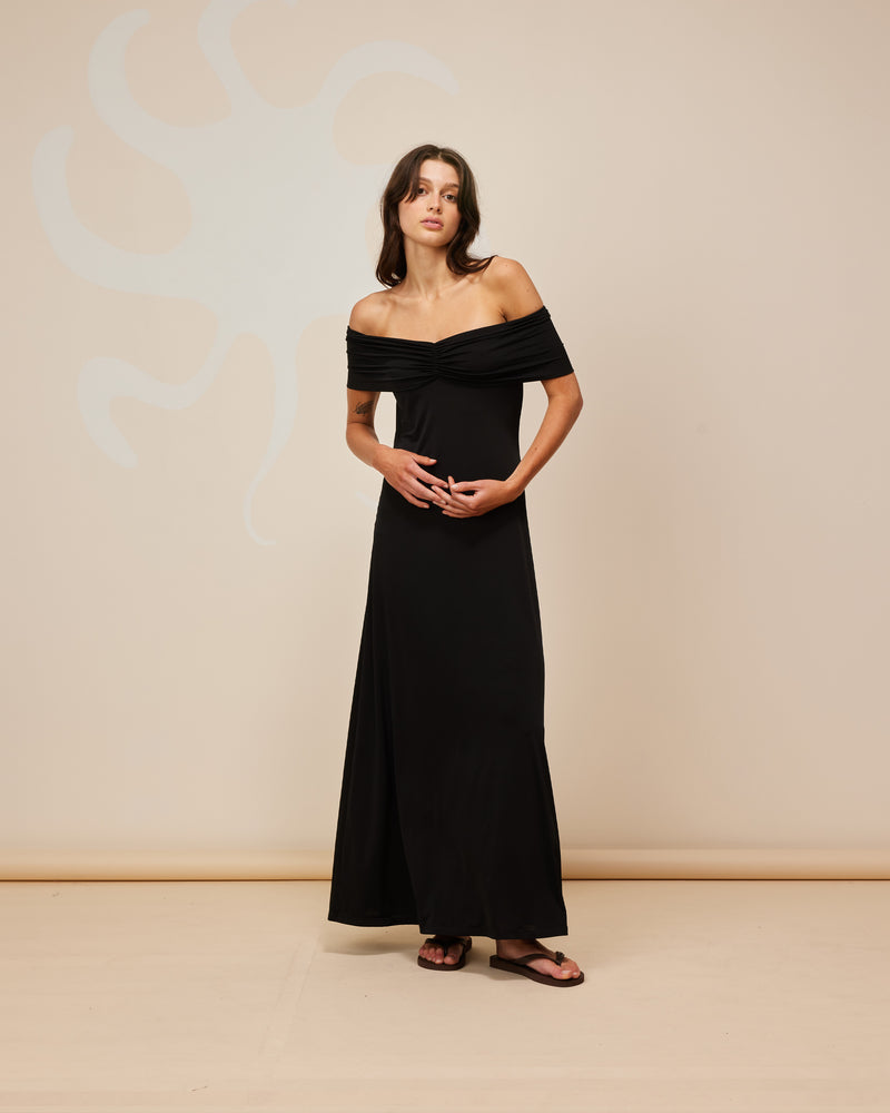 JIL OFF-SHOULDER DRESS BLACK | Off-shoulder maxi dress designed in a slinky mid-weight knit. The bust is gathered at the centre to create shape then the dress falls to a soft, A-line silhouette, simple but...