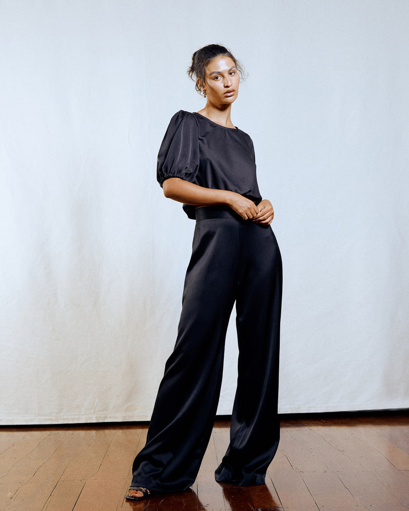 MARLEY SATIN PANT BLACK | High waisted satin pant with a wide leg. They sit comfortably on your waist and flow out to a relaxed flare. These pants also feature a zip closure at centre...