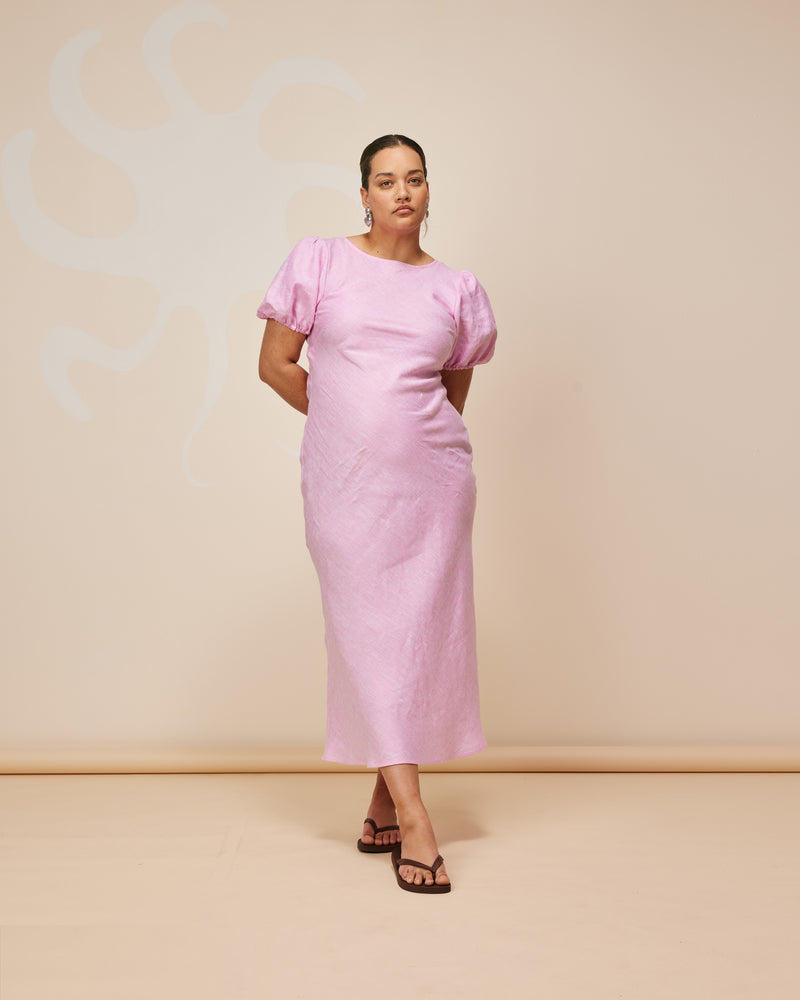KOS LINEN DRESS PINK | An update on a much loved Rubette favourite, the Kos Linen Dress is a bias cut dress with a subtle puff sleeve and cut out back. Cut from a soft...