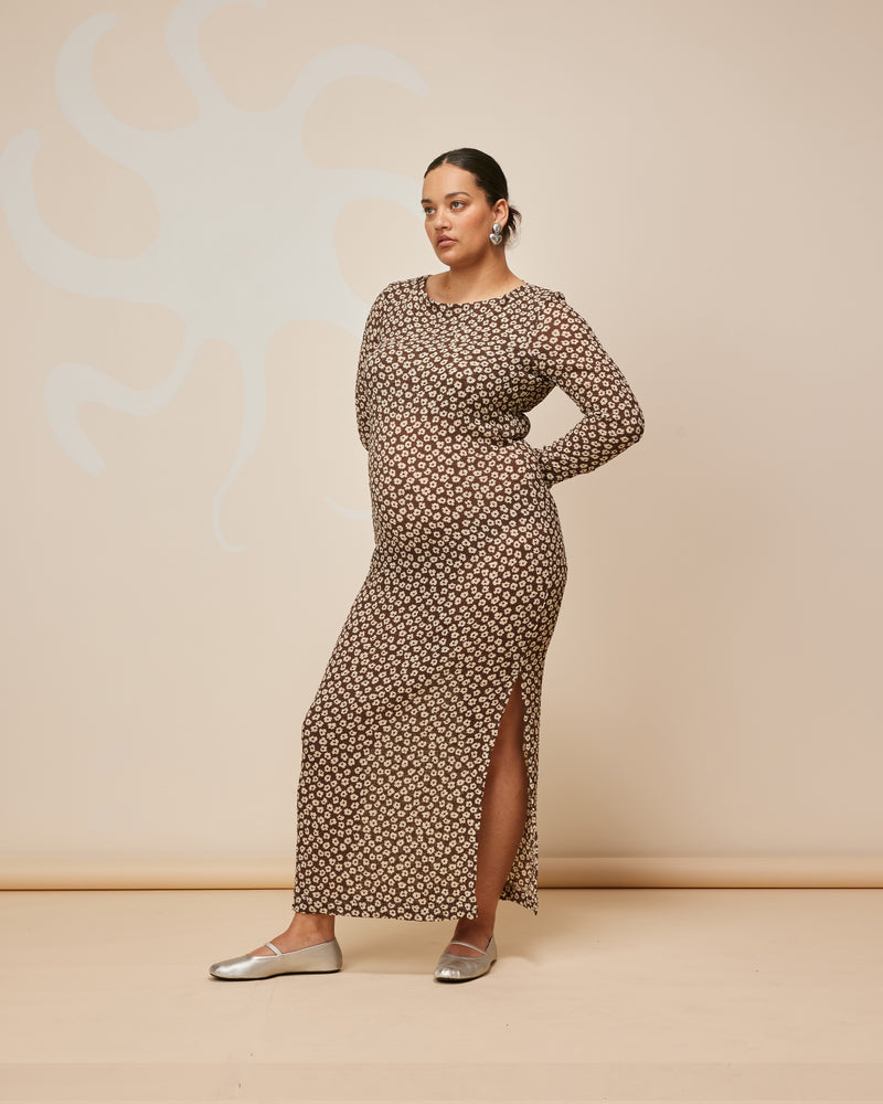 LANE CRINKLE DRESS BROWN DAISY | Longsleeve fitted maxi dress, with a high neckline and a scooped back with a tie. A side split allows you to show some skin, while the brown daisy crinkle fabric gives this dress...