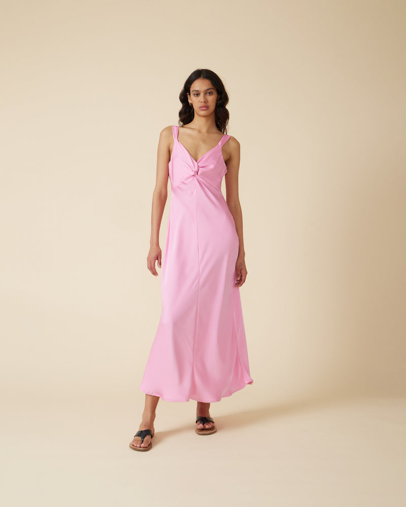 MAUDE SATIN SLIP  CANDY | Bias cut slip dress with a twisted bodice forming a V neckline and wide shoulder straps, in a luxe candy satin. With a seam detail under the bust, this piece...