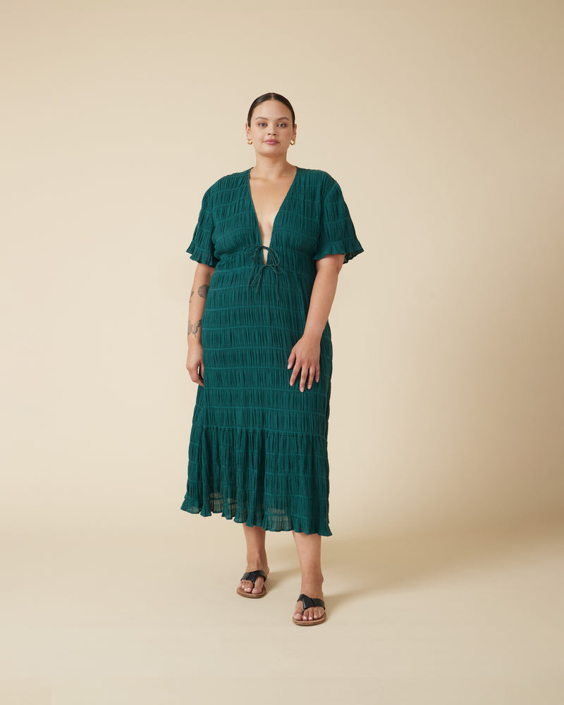 MIRELLA V-NECK DRESS PINE | 
Short sleeve midi dress with a deep V-neckline and a double drawstring waist in the signature Mirella fabric, a delicate embroidered cotton. A timeless silhouette appropriate for every occasion.

