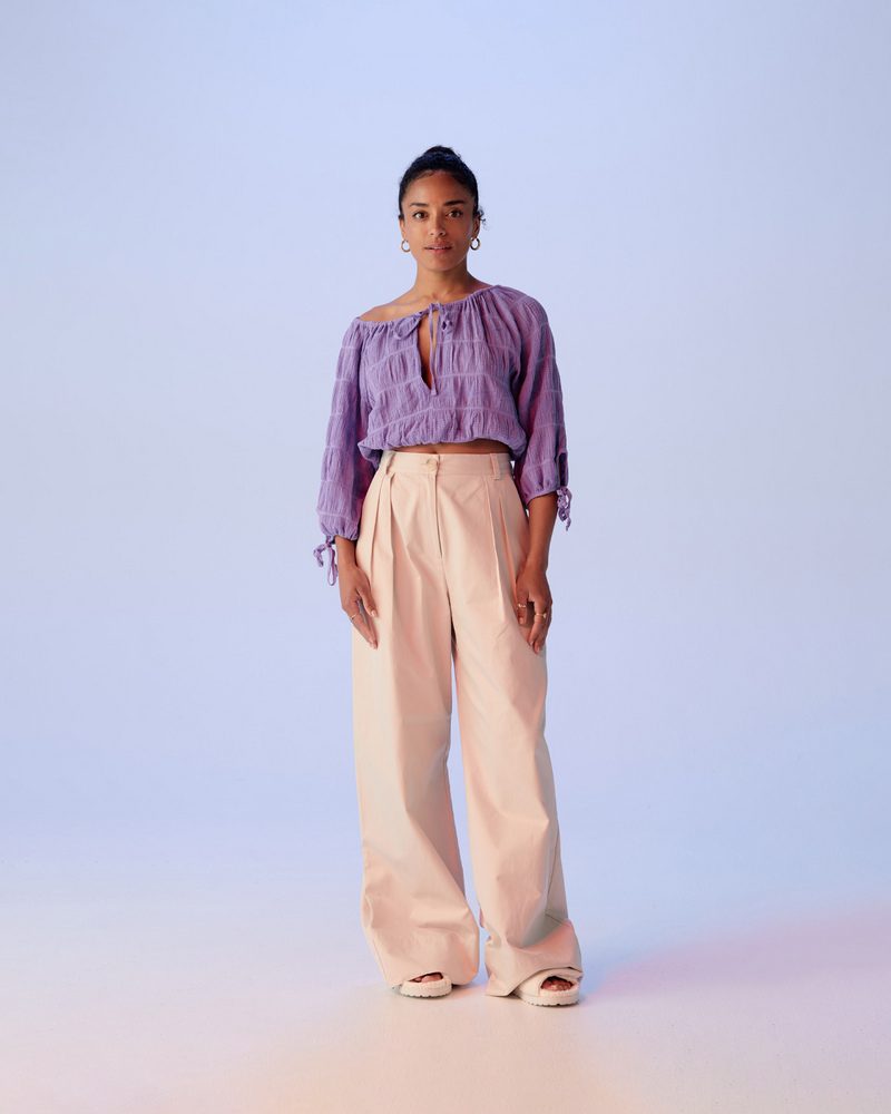 MIRELLA TIE BLOUSE GRAPE | Cropped cotton blouse with three-quarter length rounded sleeves and tie detail at the neck and cuffs. A new take on the original Mirella Crop Blouse, elasticated hems make this piece...