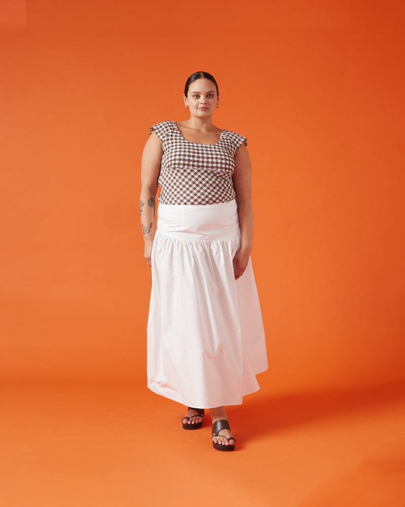 TRULLI SKIRT WHITE | Floaty basque style maxi skirt imagined in a white cotton poplin fabric. This skirt features an asymmetrical bodice-style waistline, that falls to a full, wide skirt.
