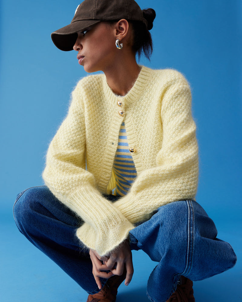 MATILDA CARDIGAN BUTTER | Button-down cardigan with gold metallic dome buttons and a slightly puff-shouldered silhouette. Features an exaggerated flute cuff crafted in a chunky mohair and wool blend.