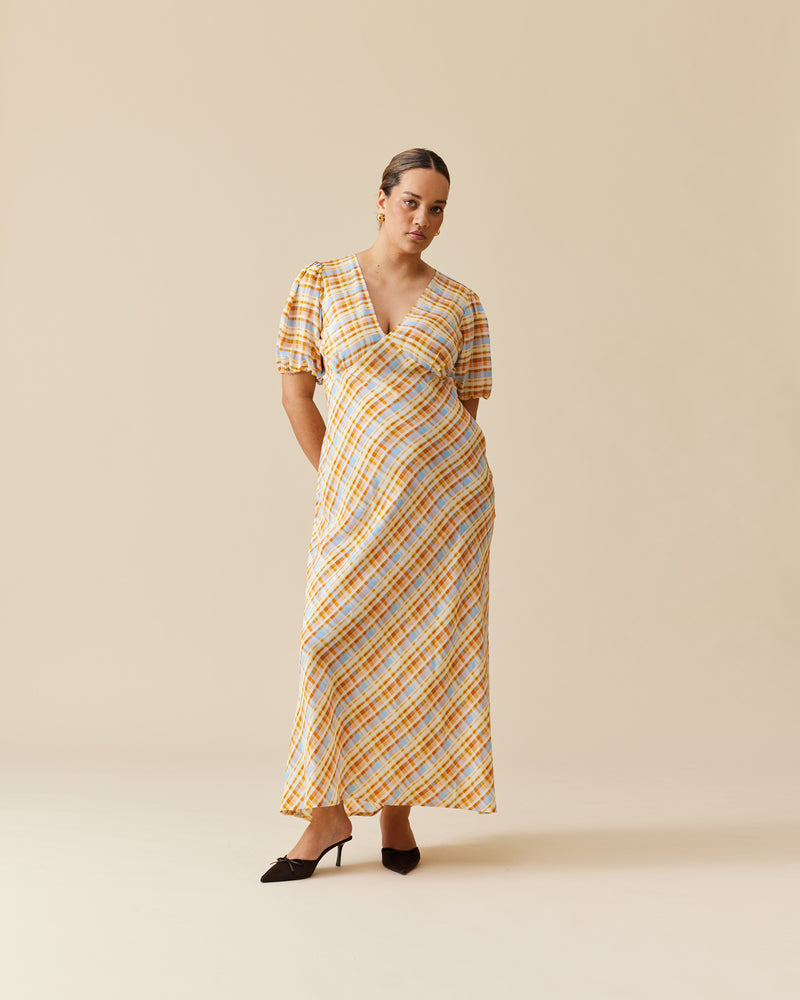 UMA SILK DRESS YELLOW TARTAN | The iconic Uma Silk Dress is a bias-cut maxi dress, featuring a front and back V-neckline and puff sleeve. Imagined in our RUBY yellow tartan silk. 
