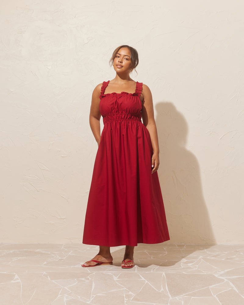 TRULLI DRESS GARNET | Sleeveless cotton midi dress with a square neckline and shirred bodice and straps. This dress falls to a full A-line skirt, that features pockets to house all your essentials.