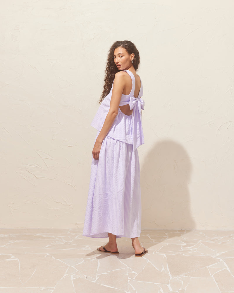 MARGIE TIE-BACK TOP LILAC STRIPE | Cotton sleeveless top with a square band at the bust. Features a bow tie detail at the back and a cut-out, the cutest summer top worn with your favourite denim....