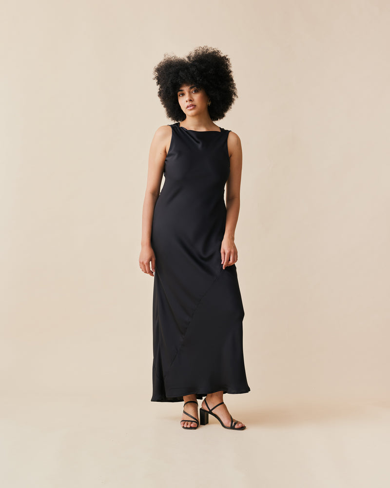 FIREBIRD COWL GOWN BLACK | Sleeveless midi dress crafted in luxe black satin. Features a minimal silhouette with a cowl back detail and a tie to cinch in the waist.
