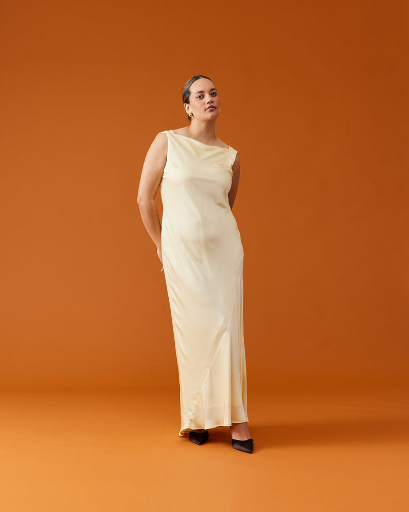 FIREBIRD COWL GOWN BUTTER | Sleeveless midi dress crafted in rich butter satin. Features a minimal silhouette with a cowl back detail and a tie to cinch in the waist.