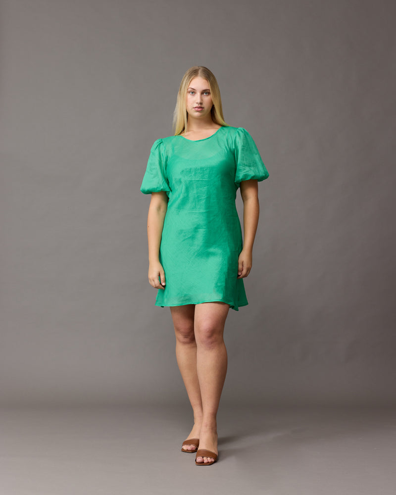 KENDALL RAMIE MINI DRESS GREEN | Bias cut ramie mini dress with puff sleeves and a keyhole button closure at the back neck. The bias silhouette of this dress gently contours the body. This dress comes...