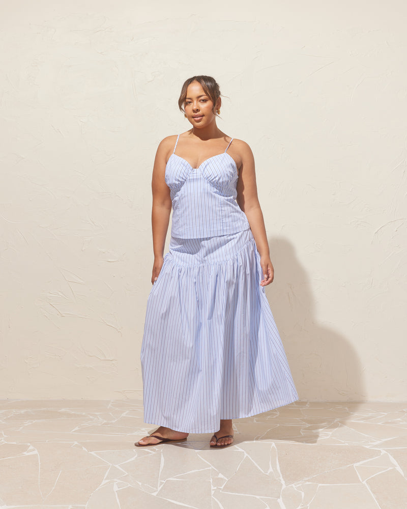 TRULLI SKIRT BLUE SKY STRIPE | Floaty basque style maxi skirt imagined in a blue stripe cotton. This skirt features a dropped bodice style waistline, that falls to a full, wide skirt.