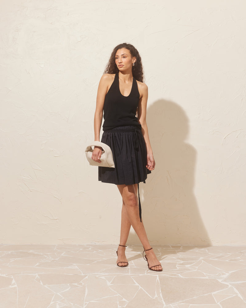 BALLERINA SKIRT BLACK | Ballerina-inspired skirt designed in a textured light-weight fabric with a slight sheen. This skirt has 2 waist ties, with pleat detailing at that waist that completes the Ballerina vibe.