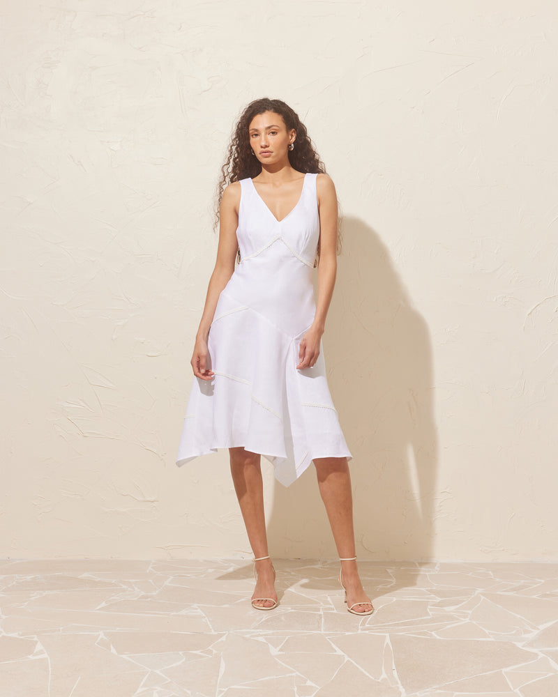 COLETTE PATCHWORK DRESS WHITE | Linen midi dress designed in a patch layout, with embroidered lace trims along the seams. This dress has a fitted body and falls to an asymmetrical, floaty hem. 