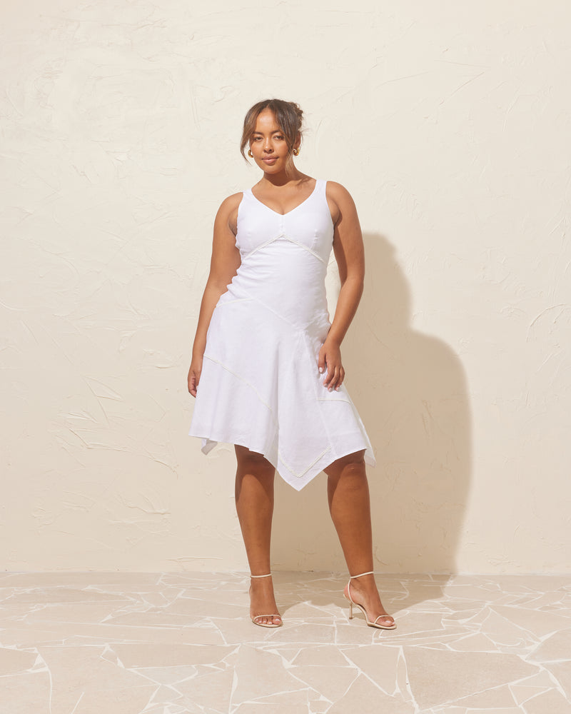 COLETTE PATCHWORK DRESS WHITE | Linen midi dress designed in a patch layout, with embroidered lace trims along the seams. This dress has a fitted body and falls to an asymmetrical, floaty hem. 