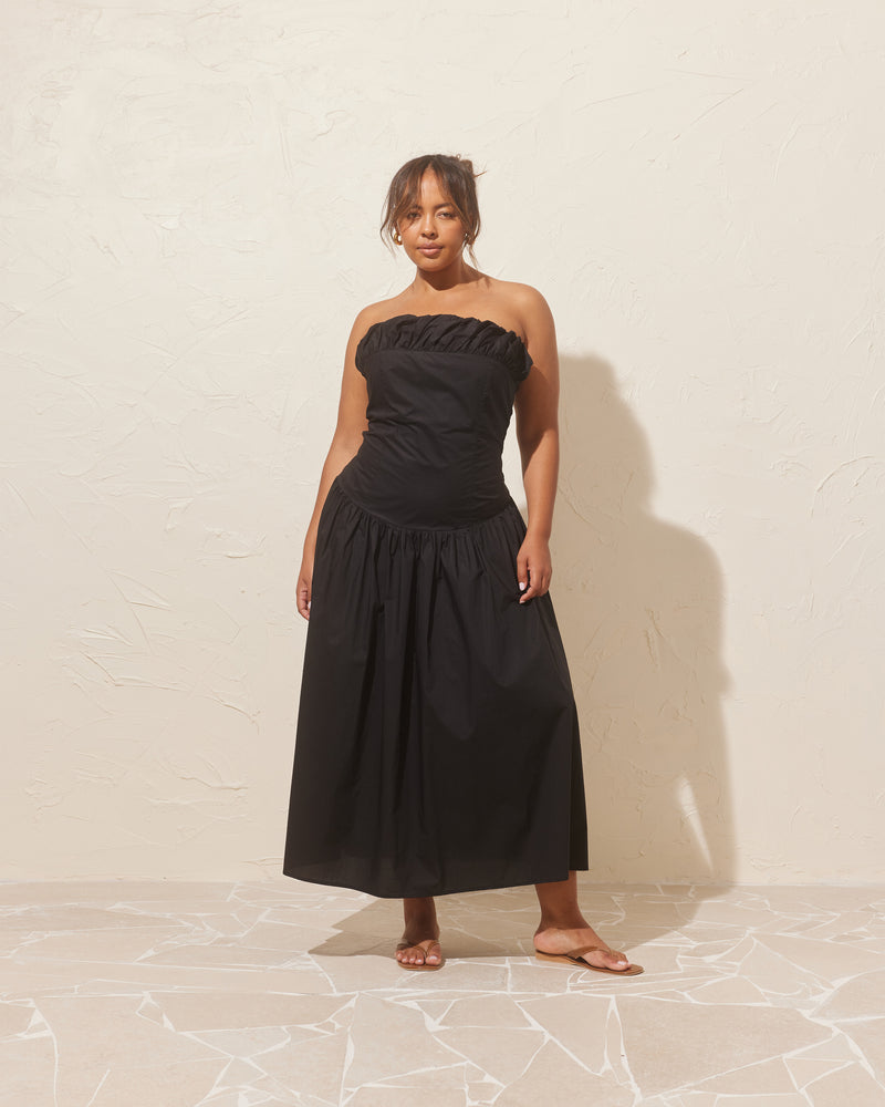 SORBET DRESS BLACK | Strapless cotton dress with a feature ruffled puff at the bust line. This dress features a dropped bodice-style waistline with a full skirt, and an elasticated shirred back to ensure...