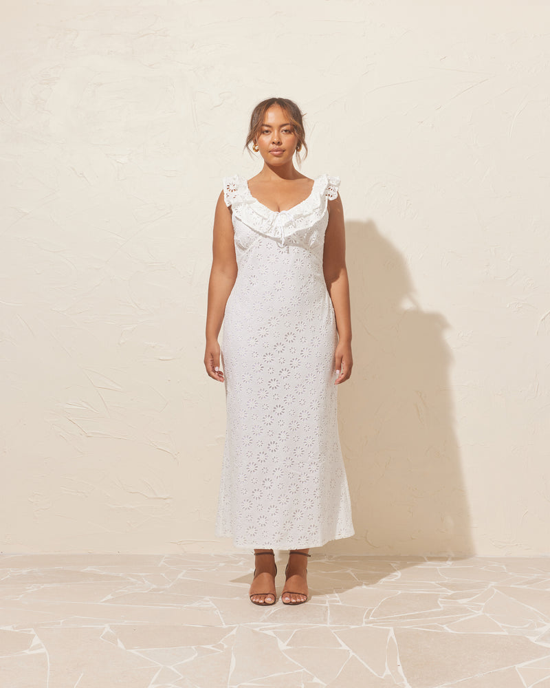 LEONIE RUFFLE DRESS WHITE | Bias cut midi dress with a feature ruffle neckline in luxe broderie cotton. Features a back tie and scooped back neck that adds to the soft look of this dress.