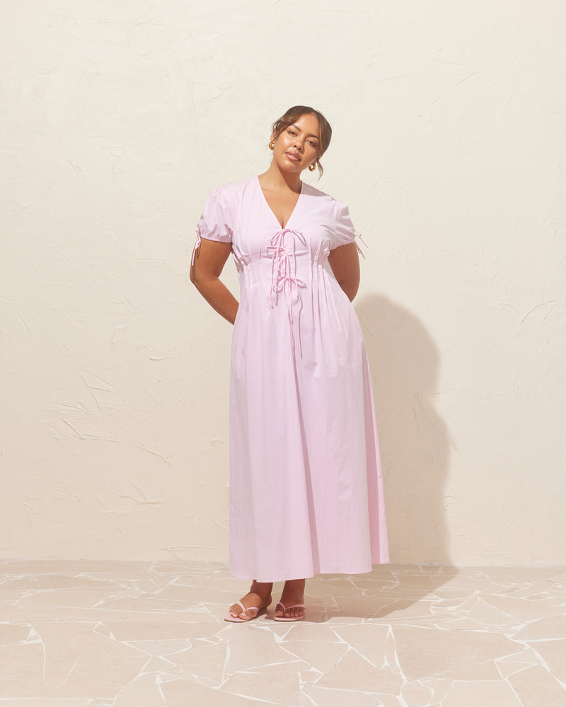 SIMONA SHIRT DRESS SOFT PINK | Short-sleeve cotton midi dress, designed with pleating and a tie front closure. Simple and sweet, this dress has a bit of stretch to ensure a good fit and a placket...