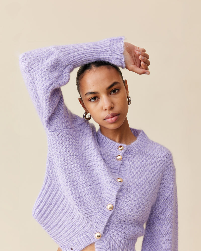 MATILDA CARDIGAN LILAC | Button-down cardigan with gold metallic dome buttons and a slightly puff-shouldered silhouette. Features an exaggerated flute cuff crafted in a chunky mohair and wool blend.