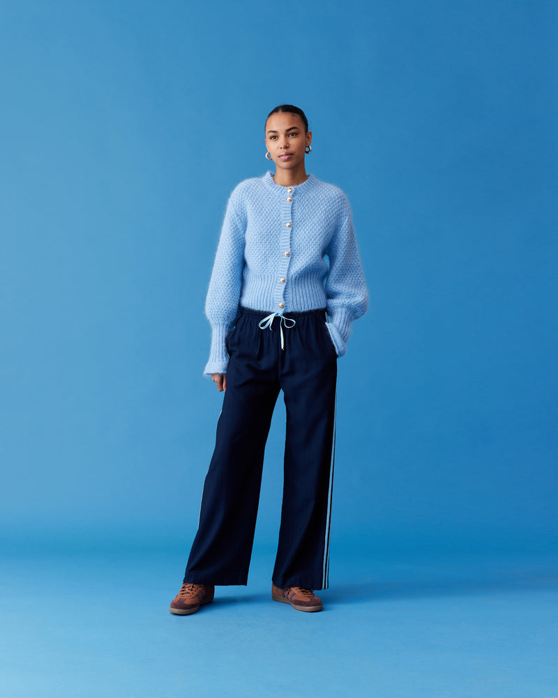 CORVETTE TROUSER NAVY BLUE | A new take on the an all-time RUBY favourite. The Corvette Trouser is now available in a two-tone version. Sporty, high-waisted pant with a wide-leg silhouette. The stripe on the...