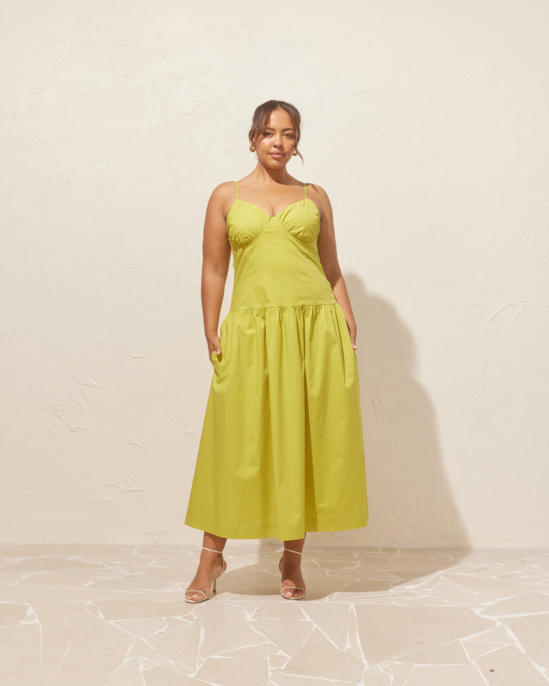 MONACO DRESS CHARTREUSE | Sleeveless midi sundress designed in a striking chartreuse cotton. This dress features dainty straps and bust detailing, creating a sweetheart neckline. The dropped waist falls to a soft gathered midi...