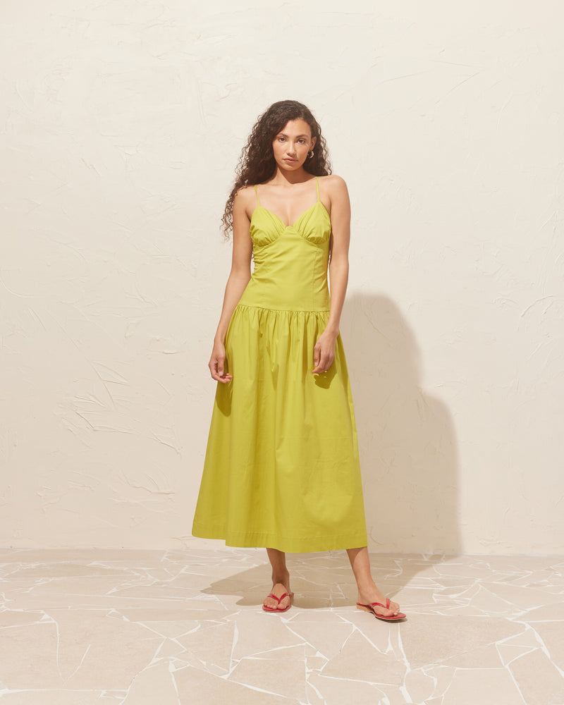 MONACO DRESS CHARTREUSE | Sleeveless midi sundress designed in a striking chartreuse cotton. This dress features dainty straps and bust detailing, creating a sweetheart neckline. The dropped waist falls to a soft gathered midi...