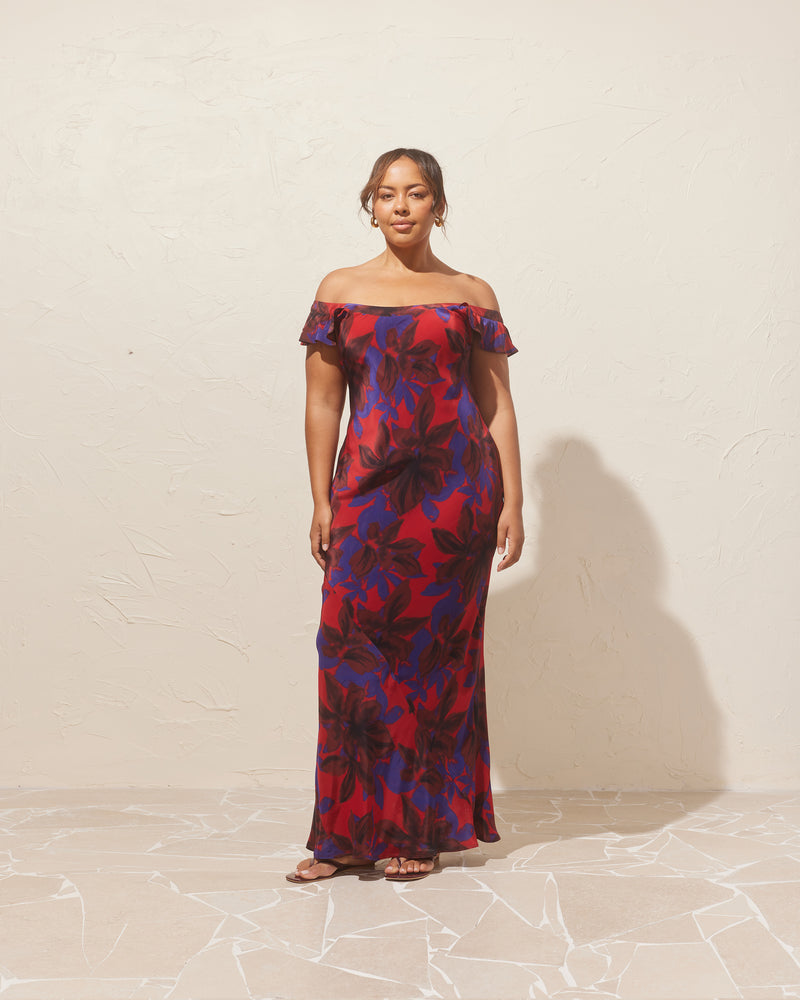 THEA DRESS SAMBA | Bias cut maxi dress imagined in a samba floral viscose fabric, with a silk-like hand feel and look. This slip dress features ruffled cap sleeves and a round neckline, that...