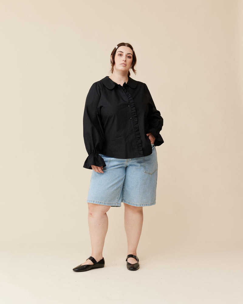 SANDLER RUFFLE SHIRT BLACK | Longsleeve black shirt with ruffles down the placket and a rounded collar. This top features elasticated ruffle cuffs, this piece is an elevated take on the classic shirt shape.