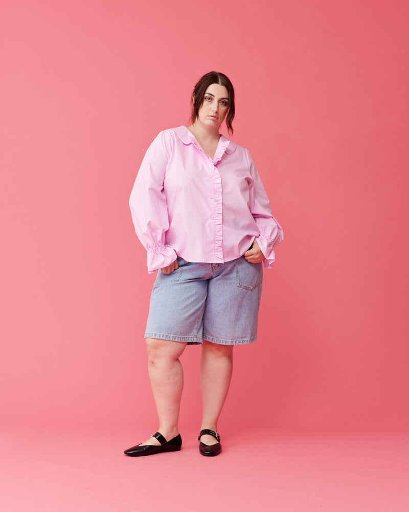SANDLER RUFFLE SHIRT PINK | Longsleeve pink shirt with ruffles down the placket and a rounded collar. This top features elasticated ruffle cuffs, this piece is an elevated take on the classic shirt shape.