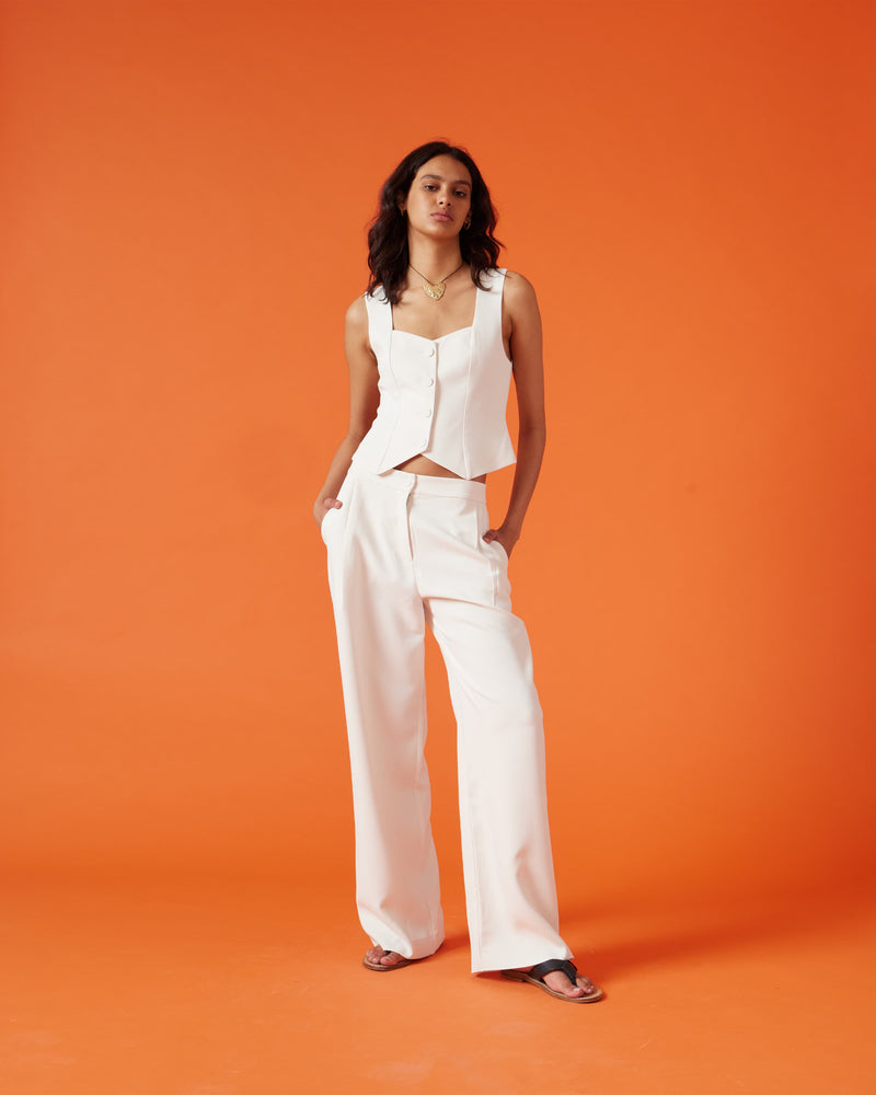 SID VEST IVORY | Waist length suit vest with a sweetheart neckline designed in an ivory colour. Featuring paneling down the front and back, this vest is perfect for spring suiting.