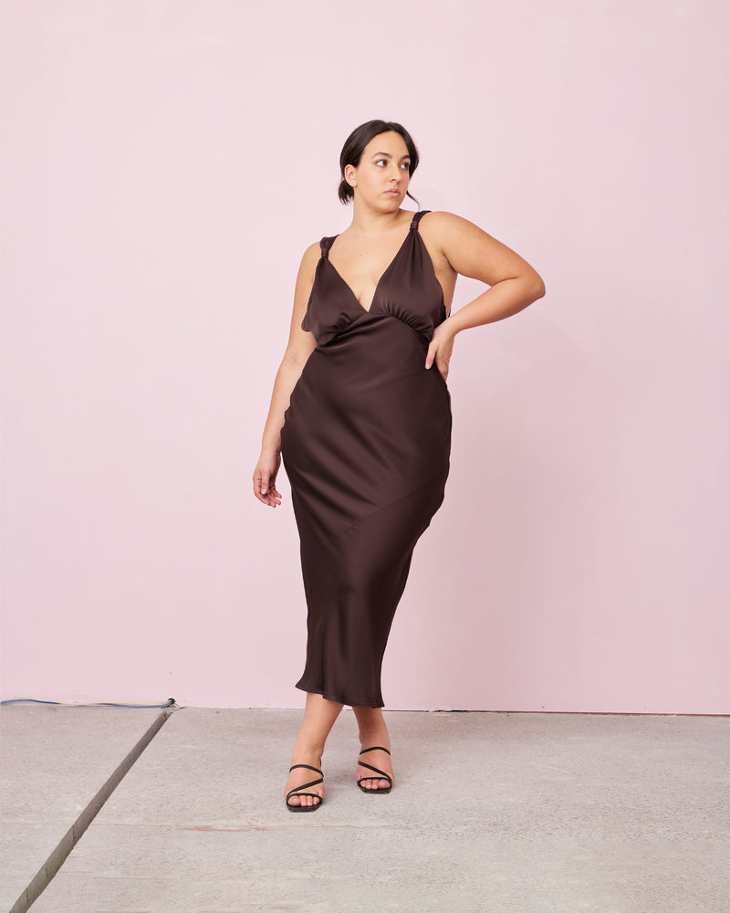 SUBLIME SATIN GOWN ESPRESSO | 
Bias cut satin sleeveless gown with a plunge neckline and open back in a luxe espresso shade. Features a knot detail at the shoulder and gathered detailing at the bust.