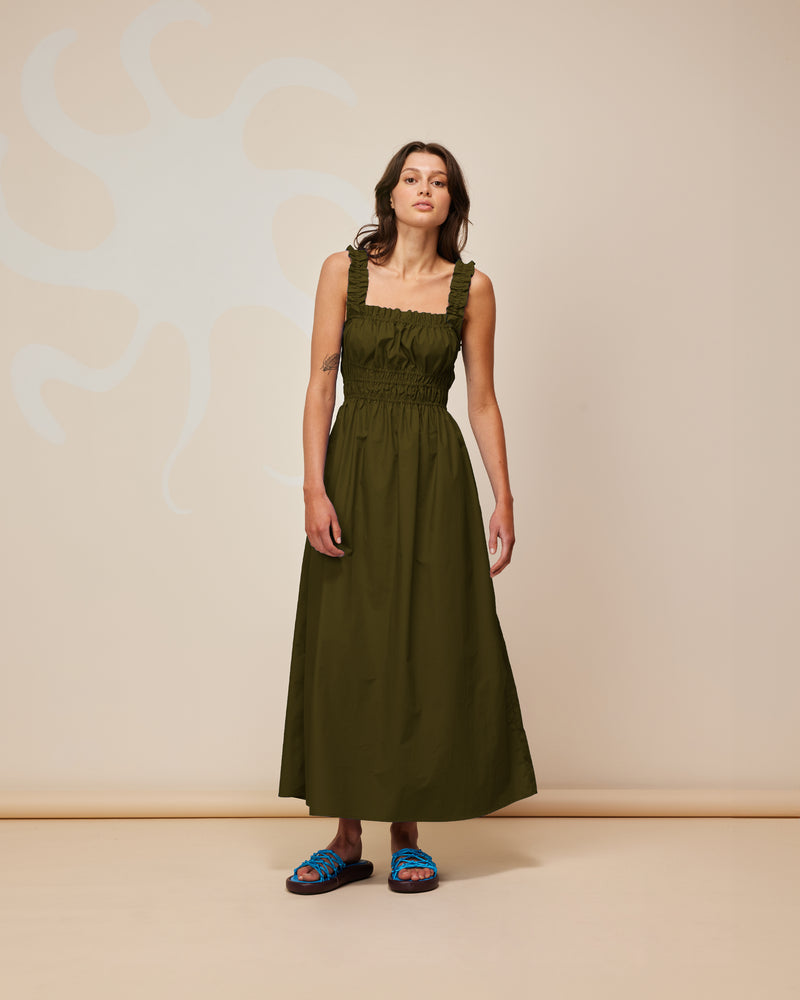  TRULLI DRESS KHAKI | Sleeveless cotton midi dress with a square neckline and shirred bodice and straps. This dress falls to a full A-line skirt, that features pockets to house all your essentials.