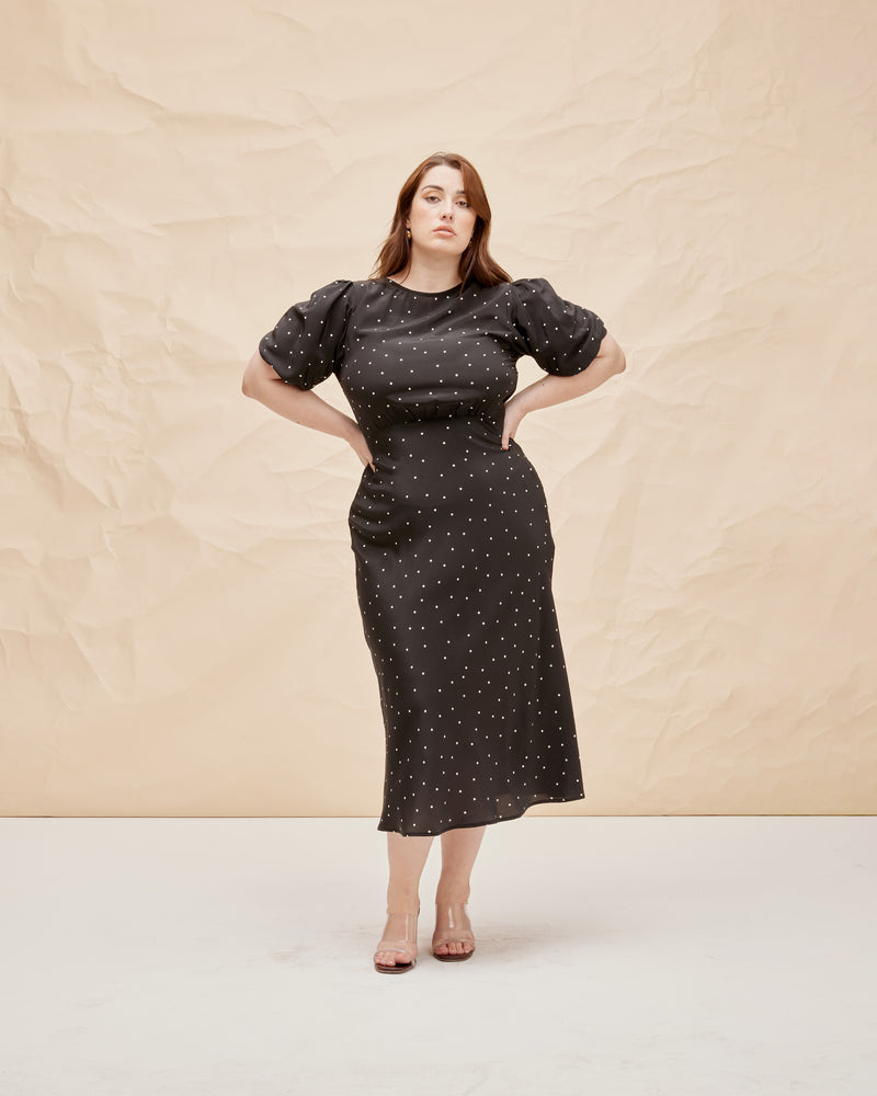 SYMPHONY SILK DRESS POLKA DOT | Bias cut silk midi dress with puff sleeves and a keyhole button closure at the back neck. The bias silhouette of this dress gently contours the body, while the polka dot silk provides...