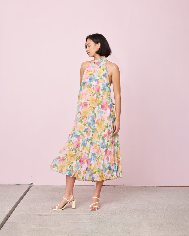 CASCADE CRUSH GOWN LOLLY FLORAL | A RUBY favourite, this gown features crushed pleats and a halter neckline with dramatic back neck ties in black. The soft a-line shape and crushed pleating creates beautiful movement as...
