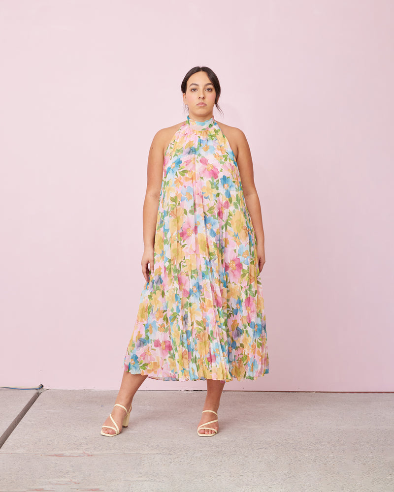 CASCADE CRUSH GOWN LOLLY FLORAL | A RUBY favourite, this gown features crushed pleats and a halter neckline with dramatic back neck ties in black. The soft a-line shape and crushed pleating creates beautiful movement as...