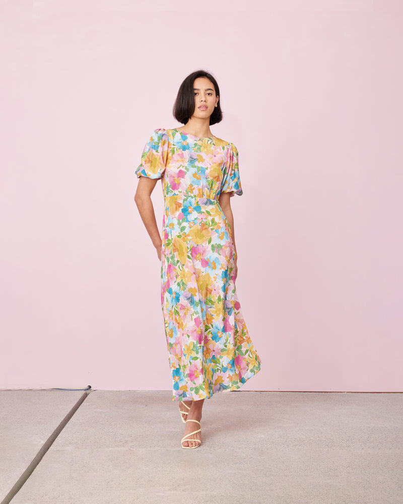 SYMPHONY SILK DRESS LOLLY FLORAL | 
Bias cut silk midi dress with puff sleeves and a keyhole button closure at the back neck. The bias silhouette of this dress gently contours the body, complimenting the floral print
