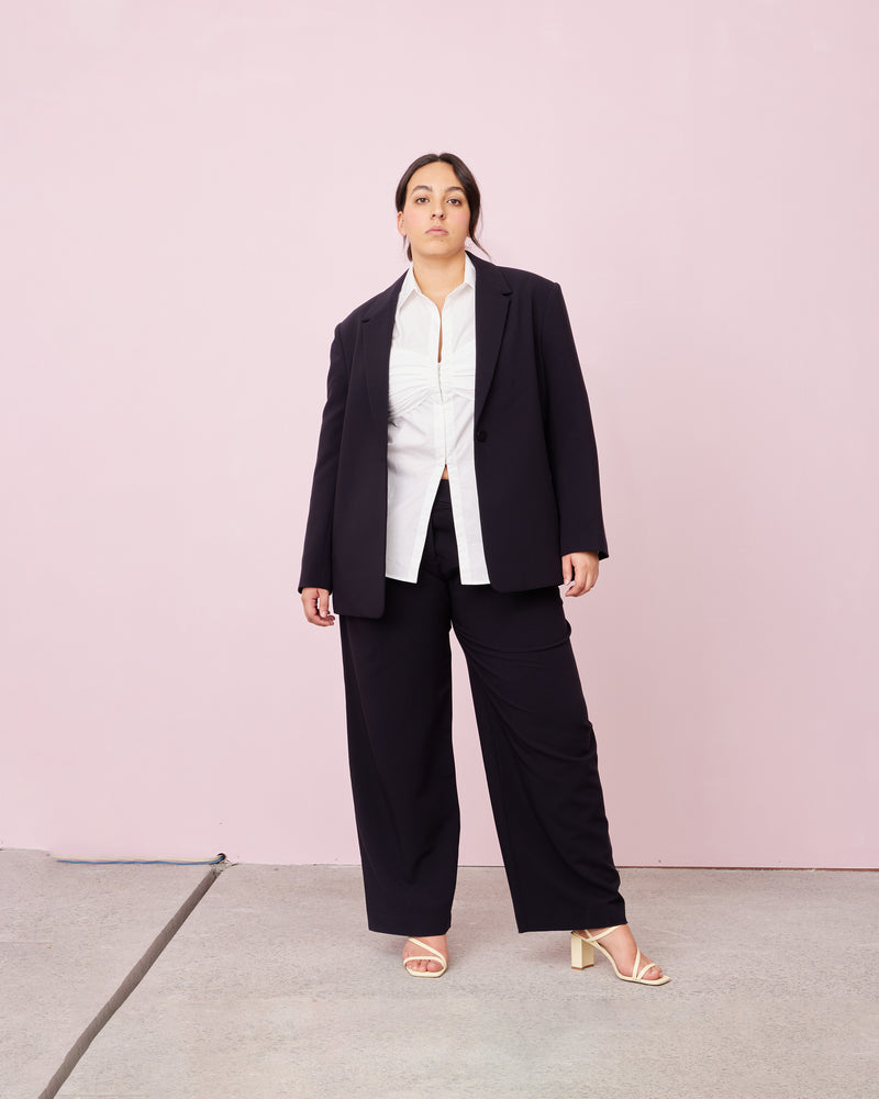 RUE TROUSER INK | Straight leg mid-waist suit trouser with a flat waistband and belt loops. These pants are versatile in that they can we be worn casual with a baby tee, or formal with...