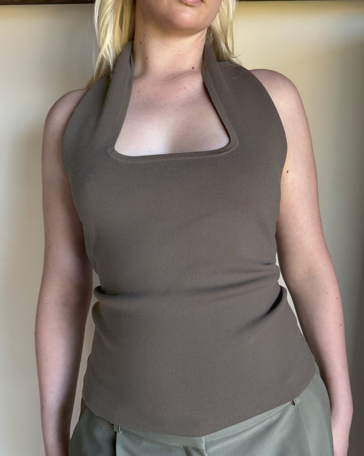 RUDI TANK STONE | A twist on the classic halter tank with an oversized strap designed to sit gathered around the neckline, crafted in a mid-weight stone knit. This tank is designed to be worn tight and hold you in when worn. Pair with...