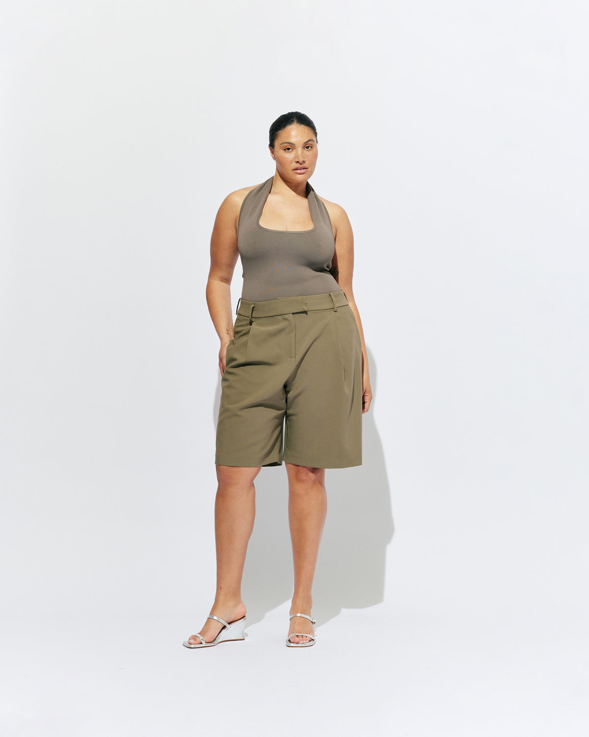 RUDI TANK STONE | A twist on the classic halter tank with an oversized strap designed to sit gathered around the neckline, crafted in a mid-weight stone knit. This tank is designed to be worn tight and hold you in when worn. Pair with...