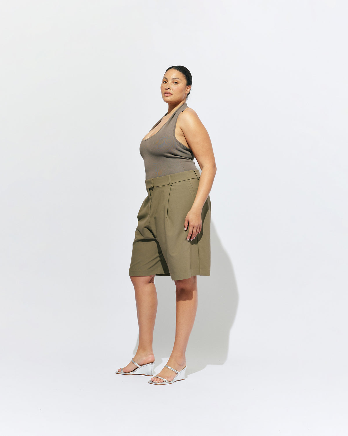 COCO SUIT SHORT MARTINI OLIVE | Classic suiting short designed in a midweight martini olive green, featuring front pleats, pockets and a wide leg. Make it a matching set with our Coco Short Sleeve Blazer or Carolyn Short Sleeve Blazer.
