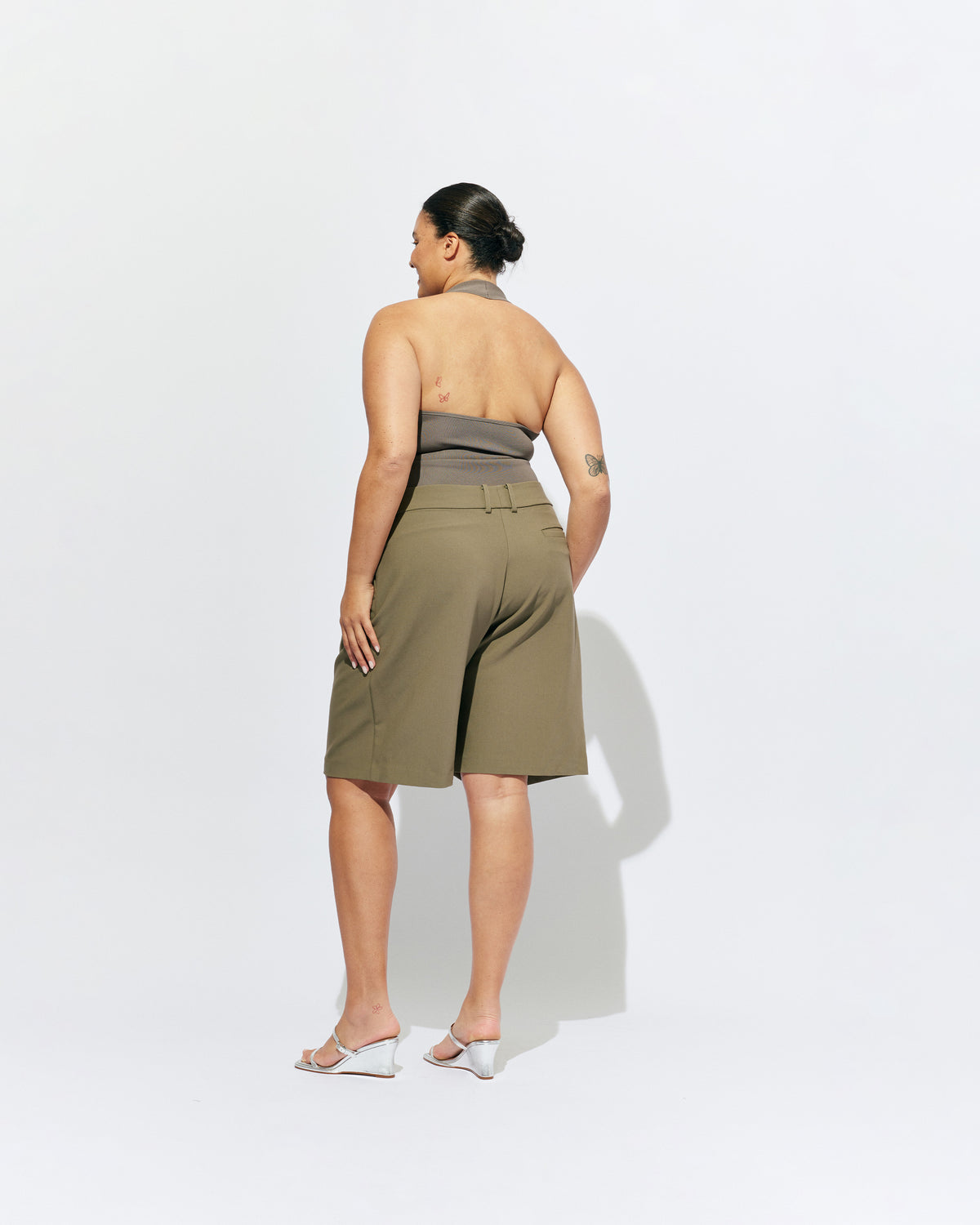 RUDI TANK STONE | A twist on the classic halter tank with an oversized strap designed to sit gathered around the neckline, crafted in a mid-weight stone knit. This tank is designed to be worn tight and hold you in when worn. Pair with...