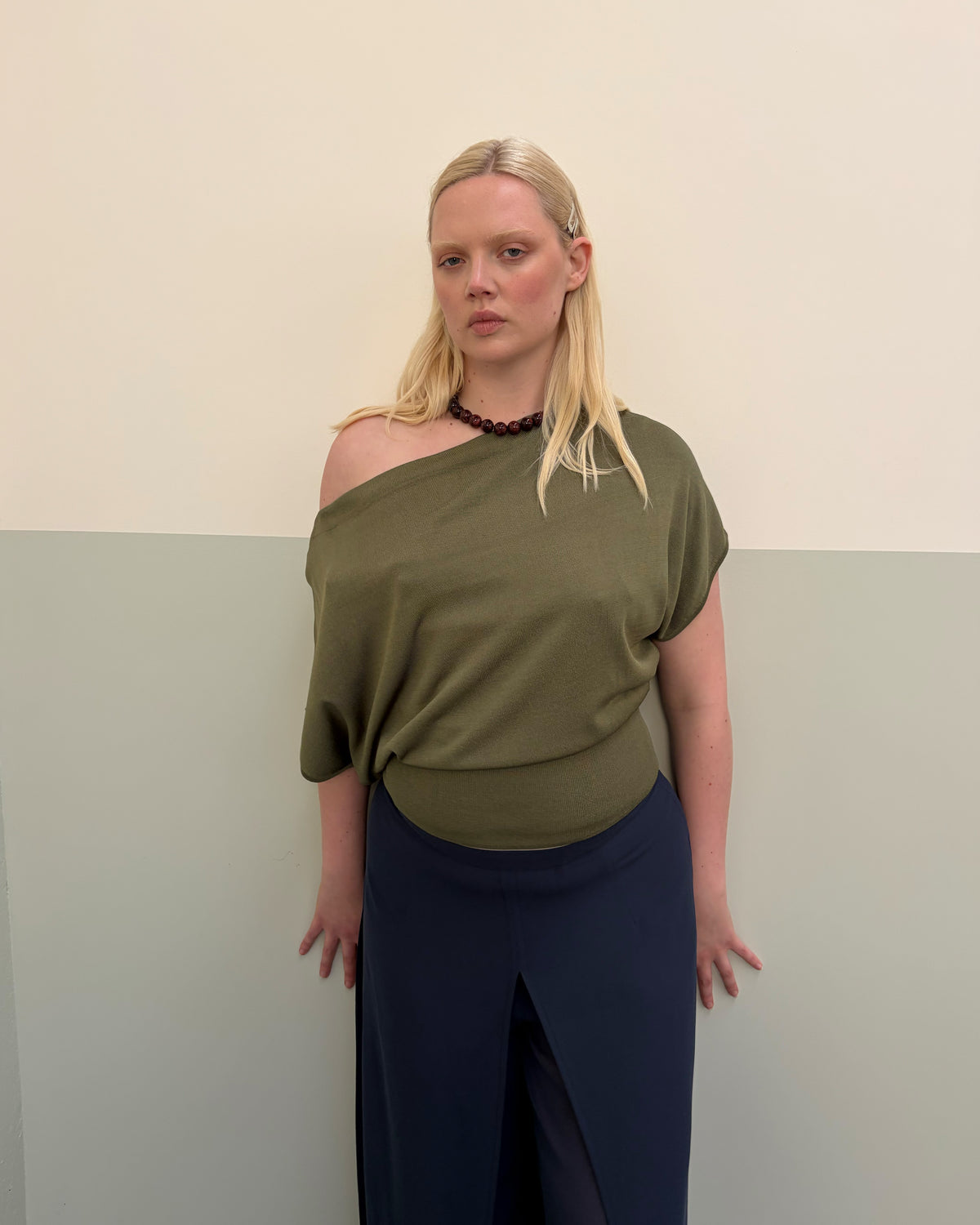 BODE BATWING SHORT SLEEVE TOP OLIVE | Off-shoulder batwing short sleeve top crafted in a mid-weight olive knit. This top is simple yet elevated and can be worn on or off the shoulder. Pair it with denim for a chic everyday look.