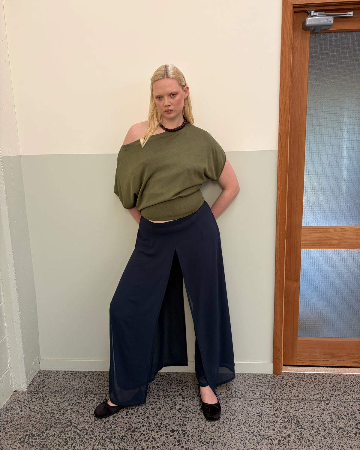 BODE BATWING SHORT SLEEVE TOP OLIVE | Off-shoulder batwing short sleeve top crafted in a mid-weight olive knit. This top is simple yet elevated and can be worn on or off the shoulder. Pair it with denim for a chic everyday look.