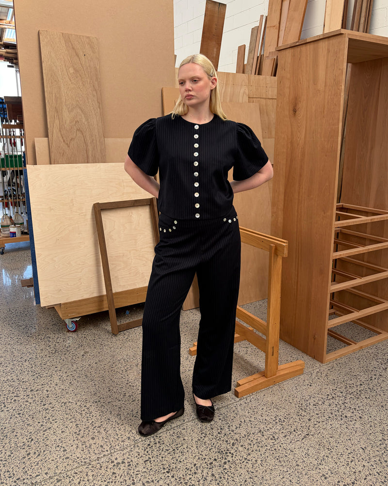 CAROLYN PANT NAVY PINSTRIPE | Classic high waisted navy pinstripe pant with an elevated twist ~ straight leg silhouette, designed in a mid weight suiting fabric and with feature shell buttons along the pockets. Make it a matching set with our Carolyn Blazer or Coco...