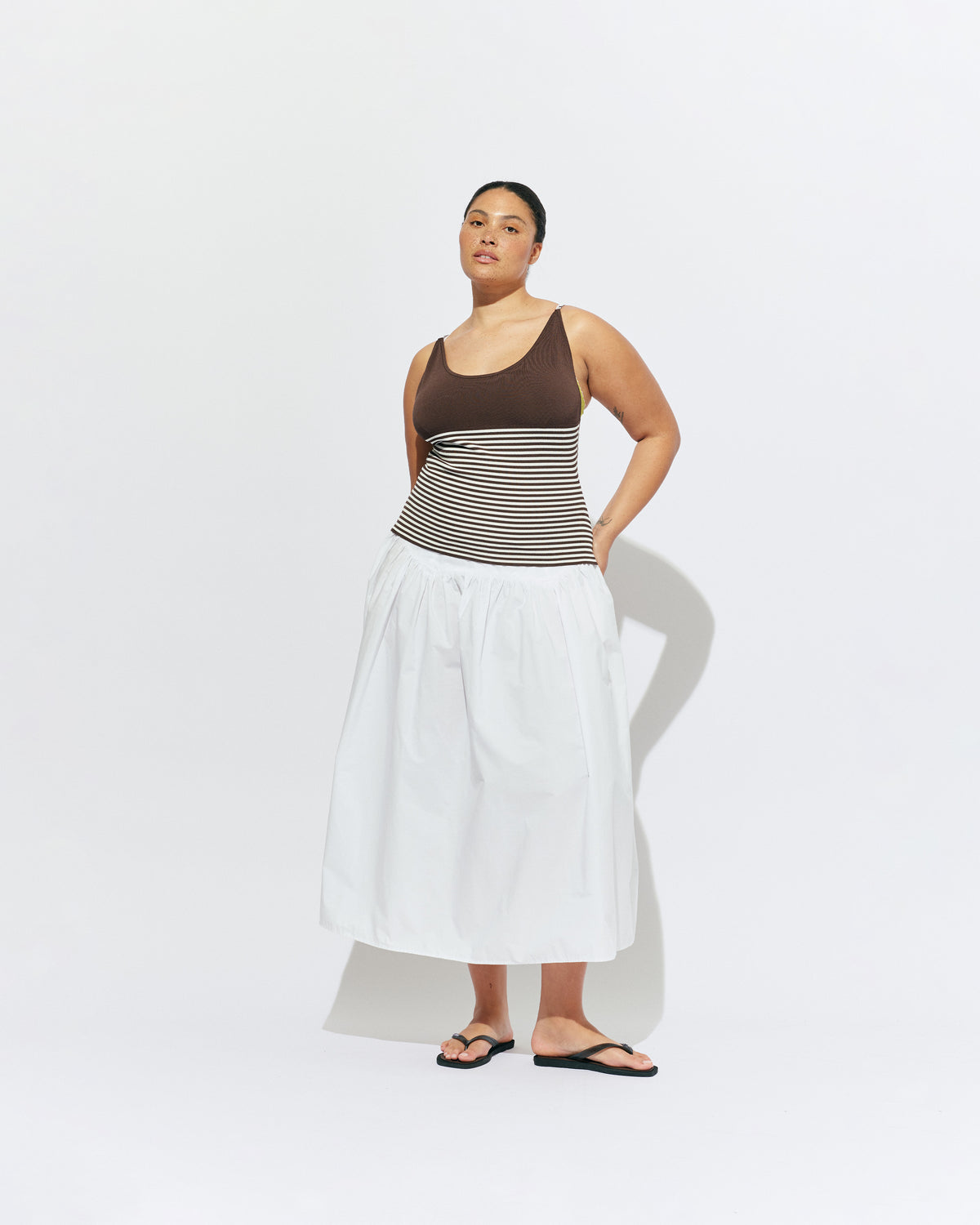 TOFFEE TANK BROWN STRIPE | Lightweight tank top designed in a brown and white striped knit. This tank features long ties which can be worn multiple ways, from a cross over back to a halter, and is the perfect throw-on top for the summer season. 