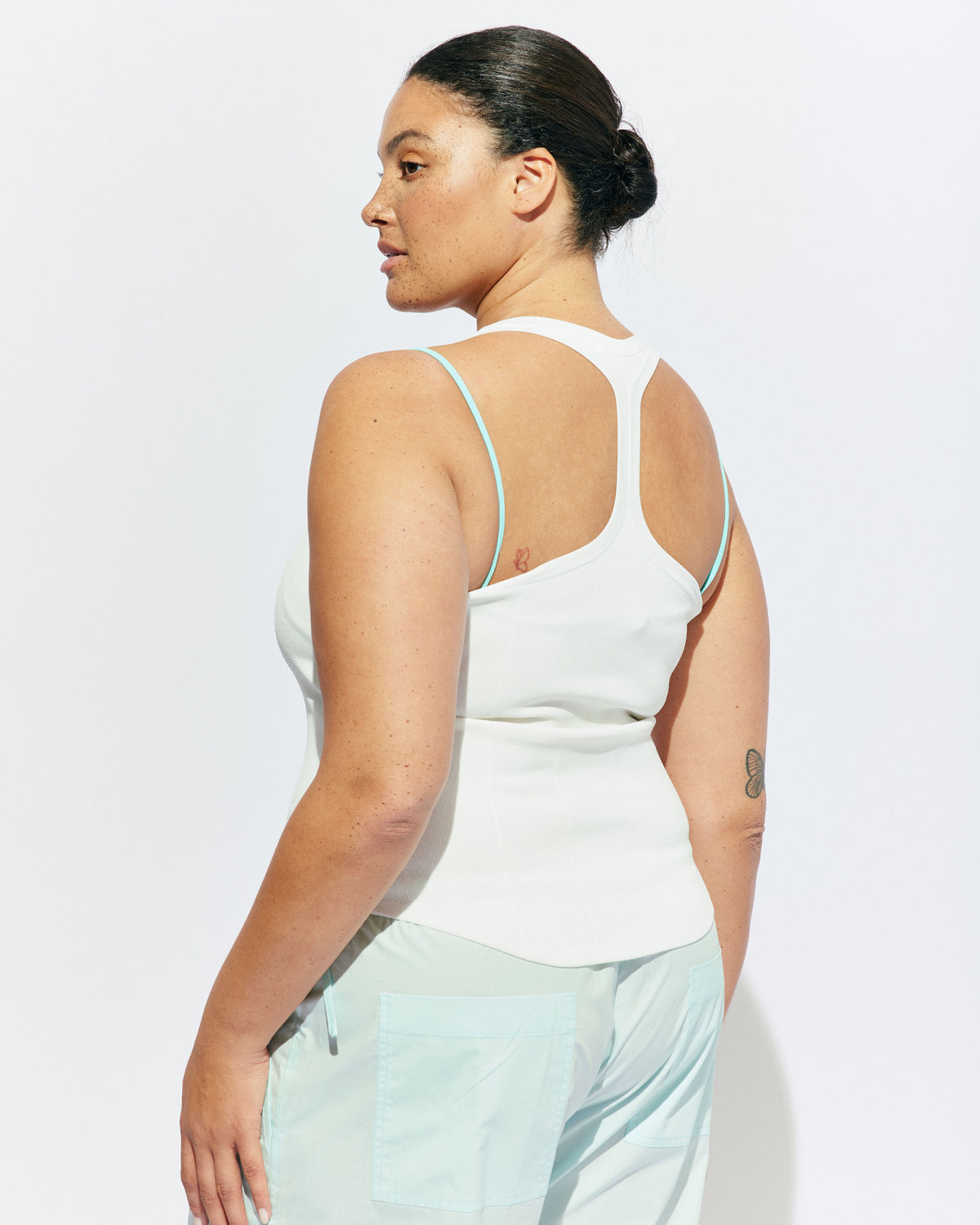 SOL TANK WHITE | A wardrobe staple for all year round, this classic racerback tank top is designed in a mid-weight white knit. Wear as a base layer under your winter favourites, or as an everyday go to during the warmer months. 