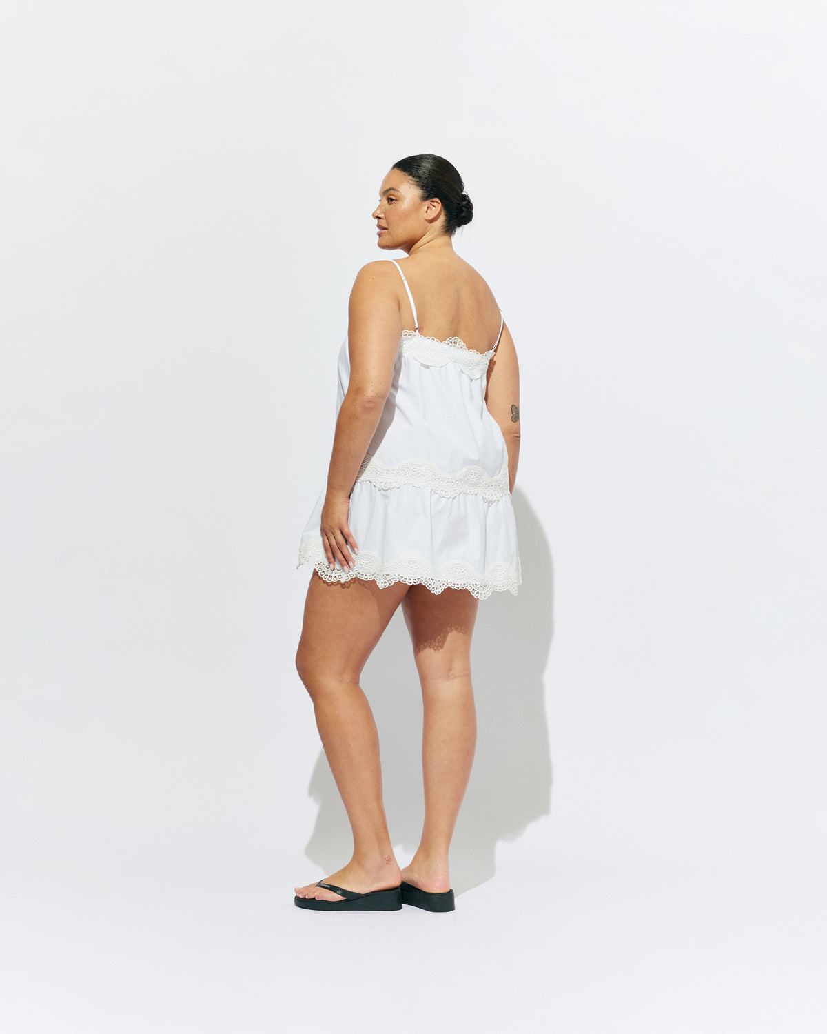 TIDE MINI DRESS  WHITE | A-line mini dress with broderie trim details along the hem and bust, designed in our white organic cotton. With tiered skirt and adjustable straps, this is the perfect everyday summer dress.